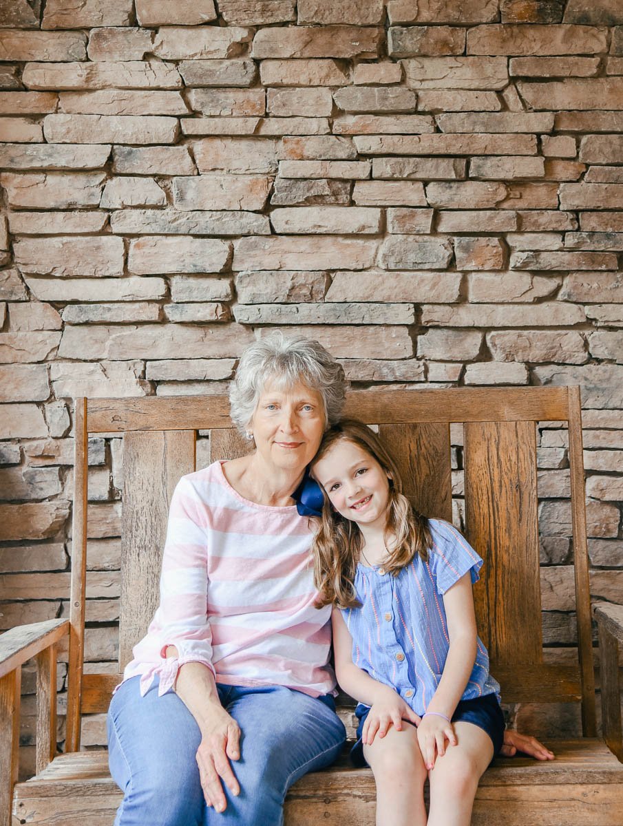 Child and Grandmother Sitting on Bench Together