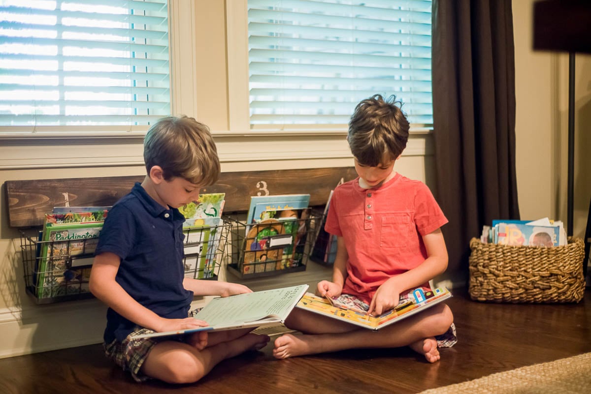 Boys Sitting in the Floor Reading Books Together