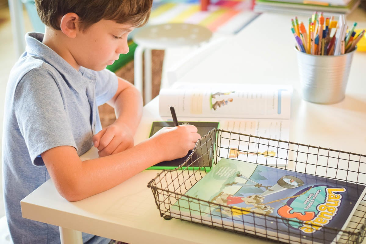 Young Boy Writing on a Digital Tablet
