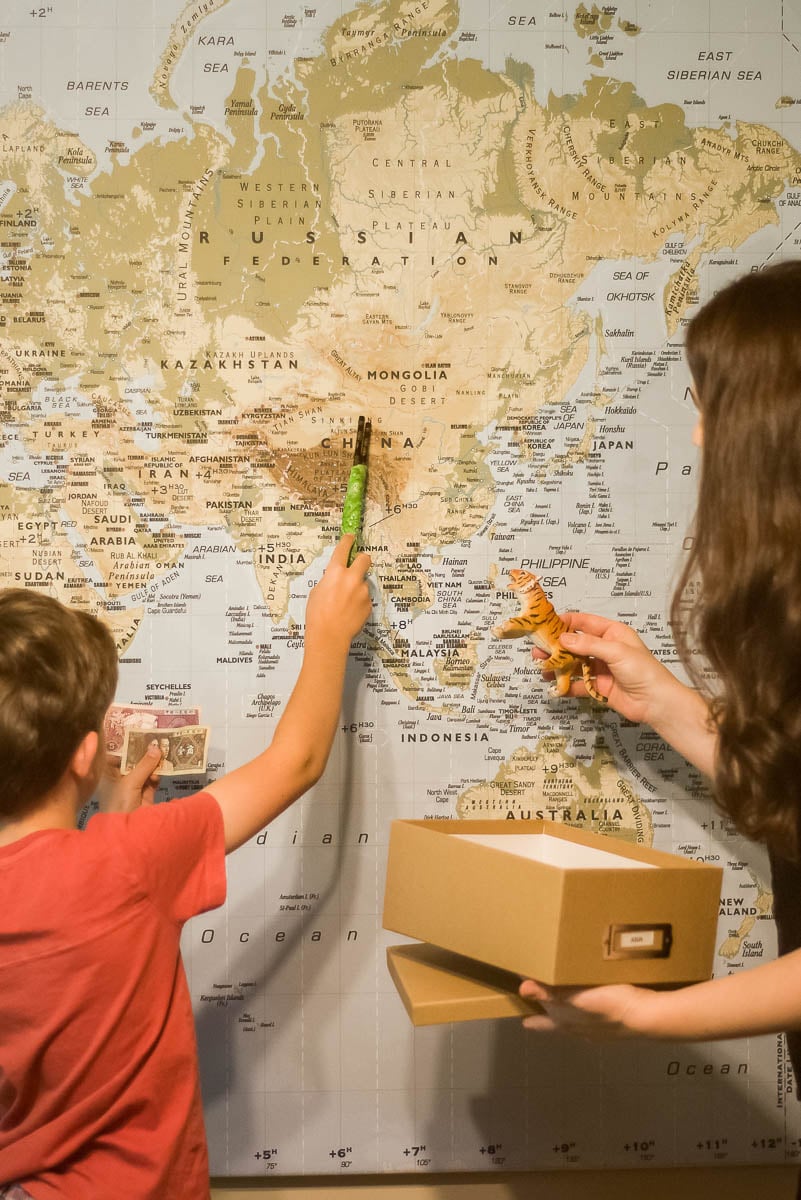 Young Student Pointing to a World Map
