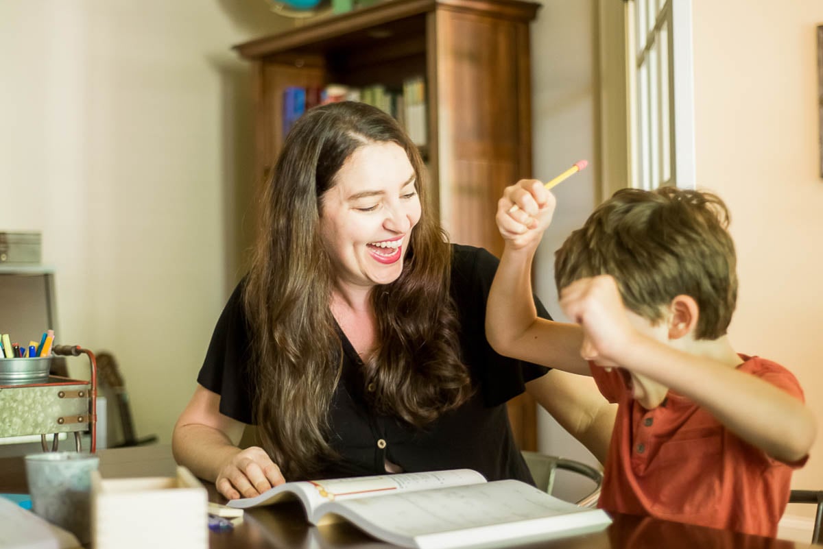 Mom and Son Working in Math Workbook Together