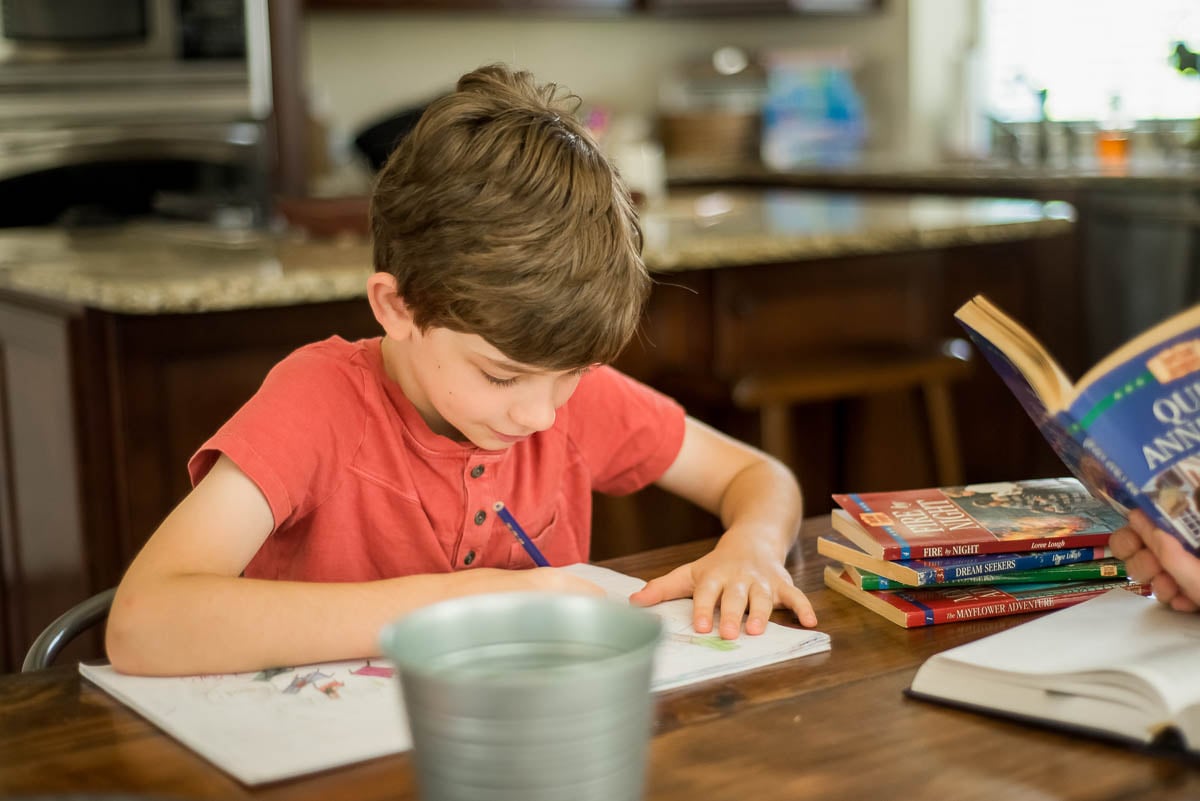 Young Boy Drawing in a Spiral Bound Notebook