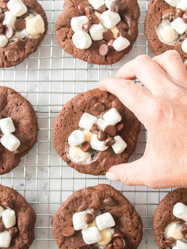Hot Chocolate Cookie Being Picked Up Off of Wire Cooling Rack