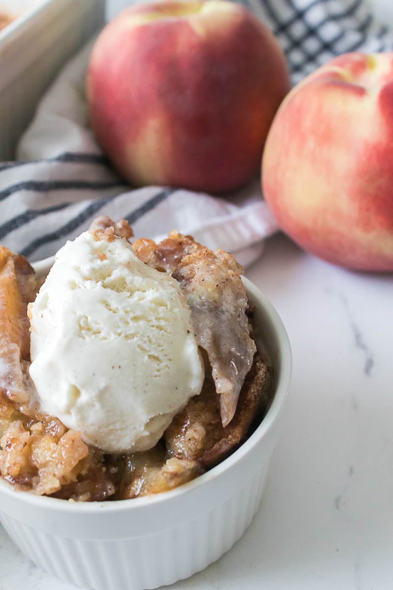 Peach Cobbler in a Glass Baking Dish - Topped with Vanilla Ice Cream