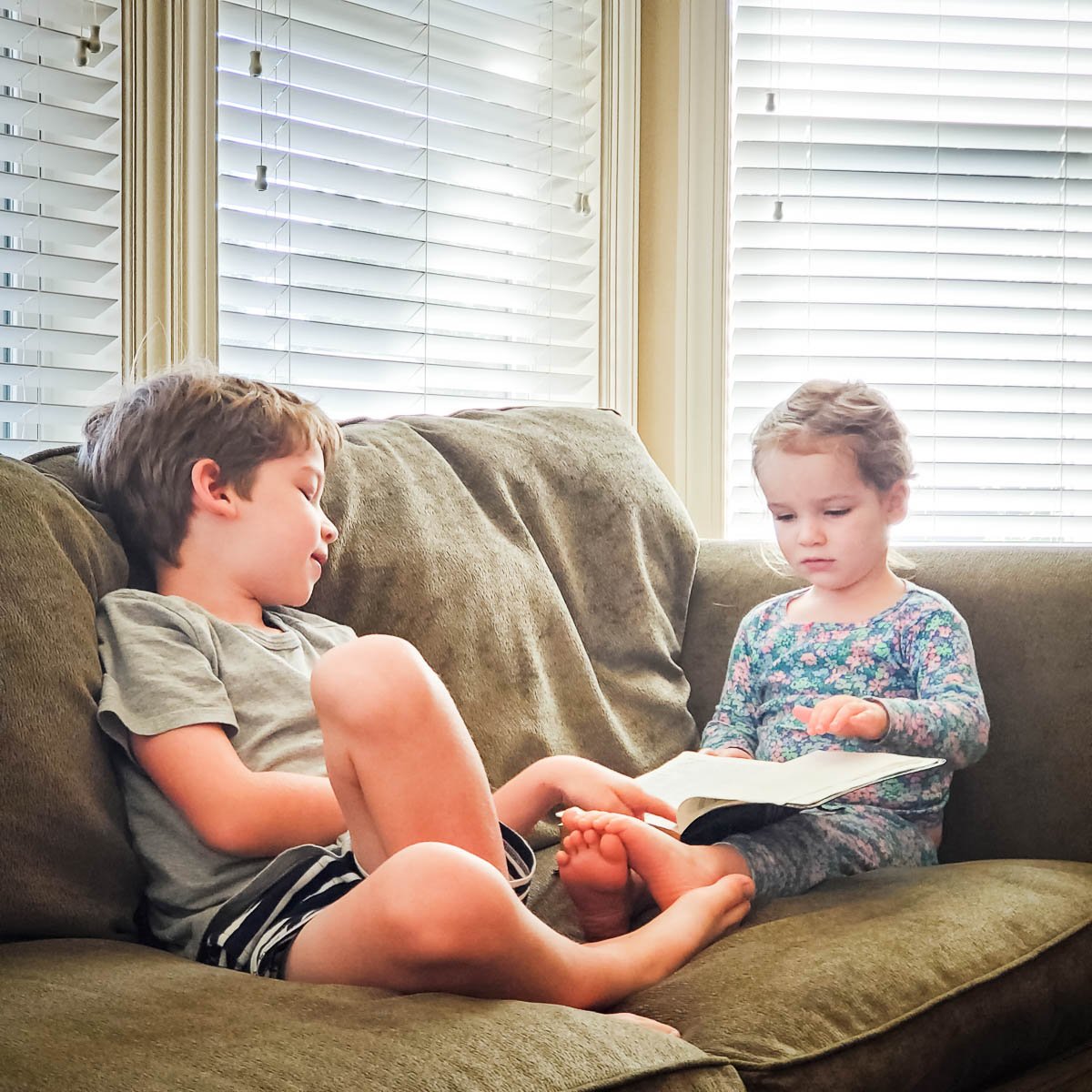Children Reading Together on the Couch