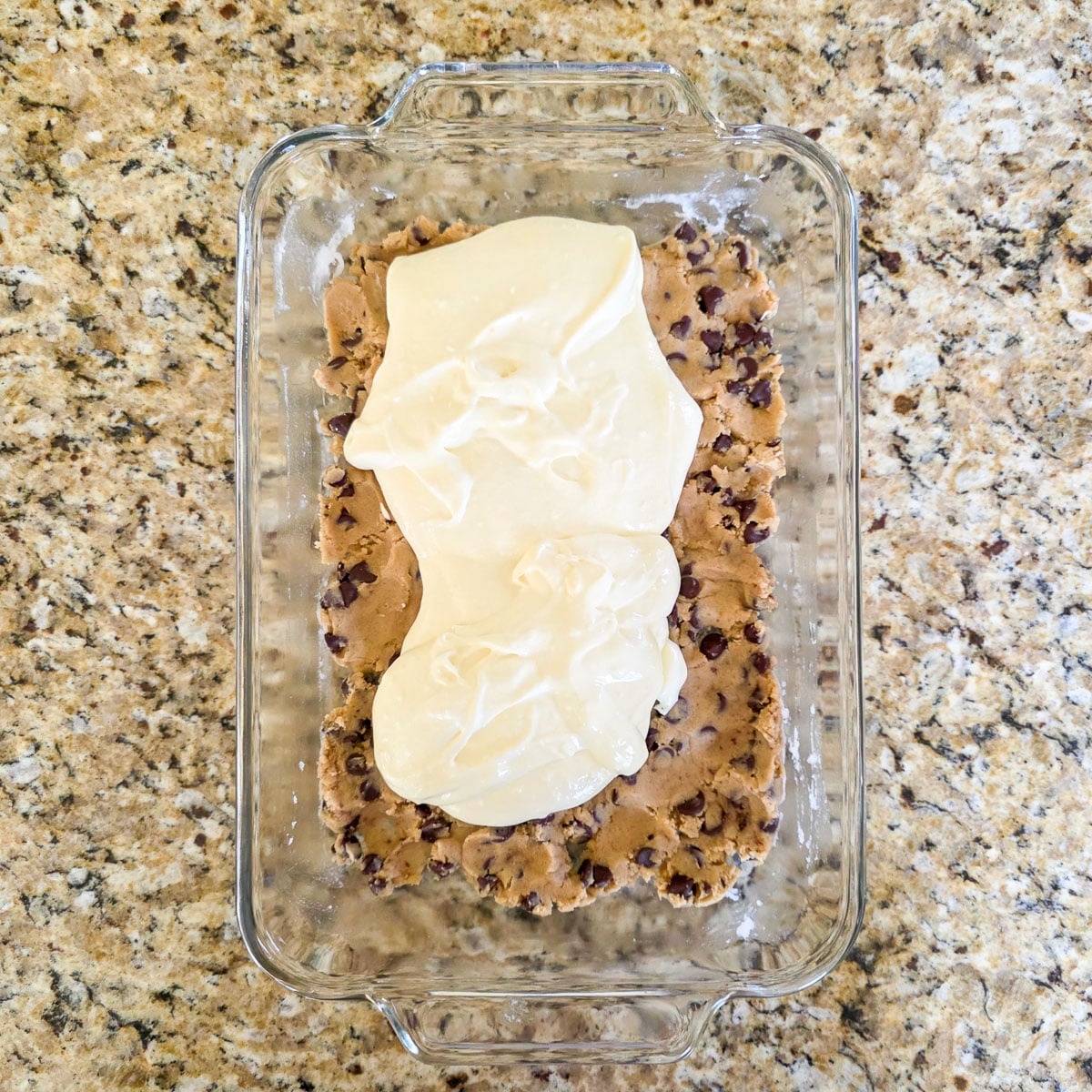 Cookie Dough and Cream Cheese Mixture Pressed into a Glass Baking Dish