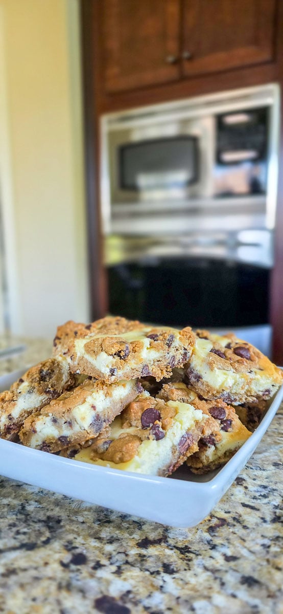 Chocolate Chip Cheesecake Bars on White Serving Plate