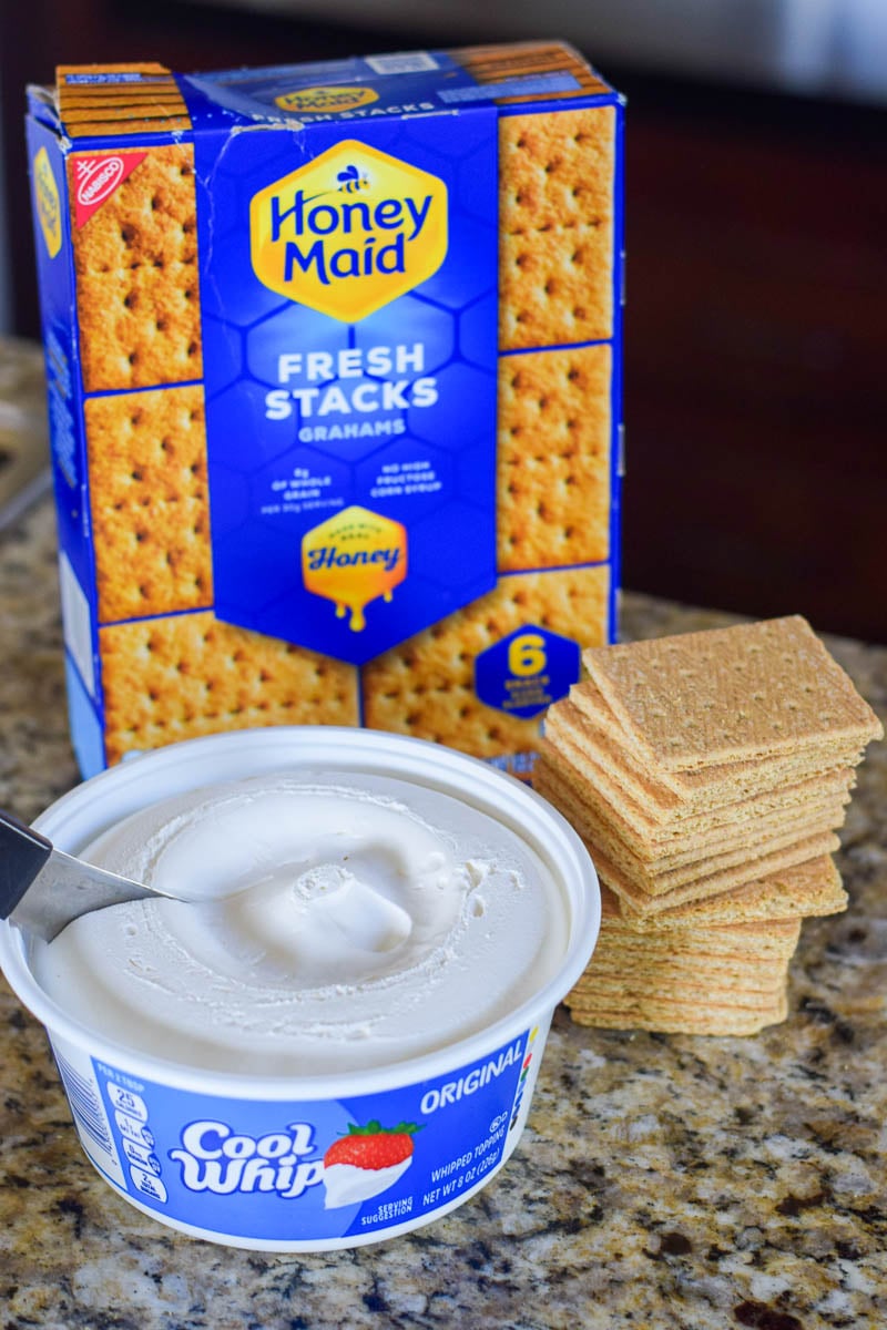 Box of Graham Crackers and Tub of Cool Whip Sitting on Kitchen Counter