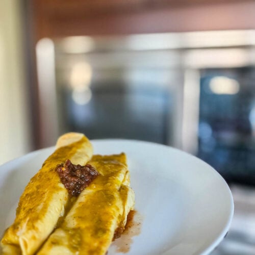 Two Chicken Enchiladas on a Serving Plate