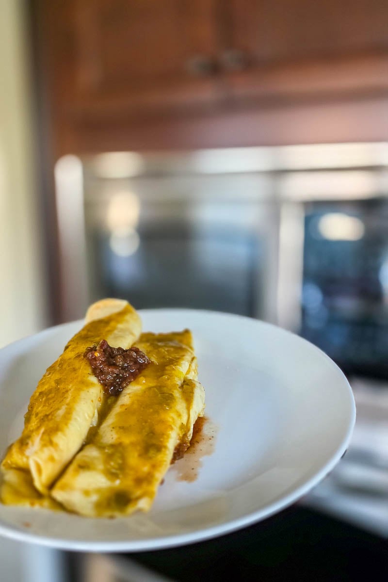 Two Chicken Enchiladas on a Serving Plate