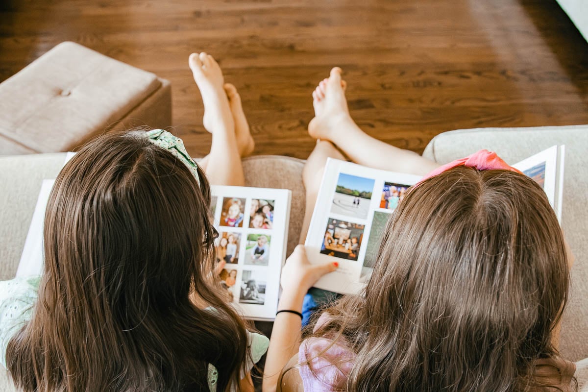 Two Girls Looking at Photo Albums