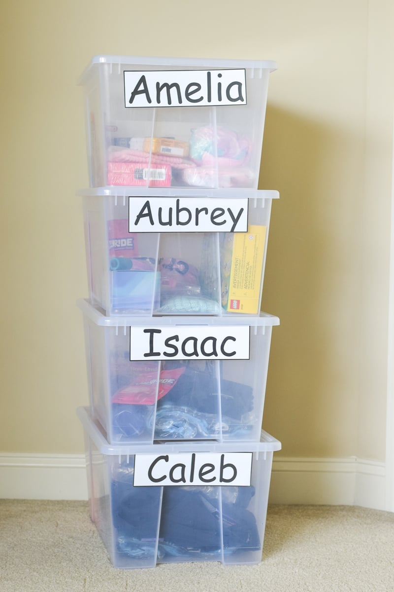 A Stack of Four Plastic Totes Used as Gift Bins