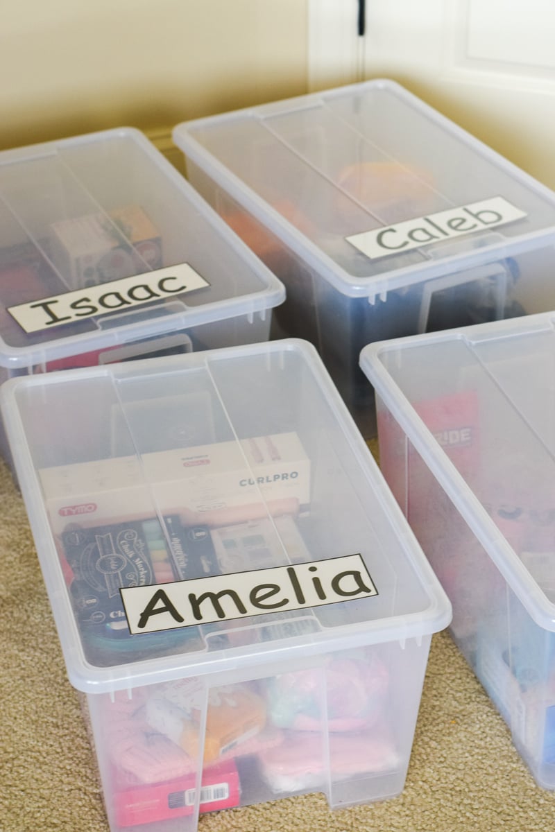Four Plastic Totes Filled with Gifts for Kids